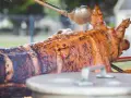 Un cochon à la broche doré et juteux, arrosé d'une sauce savoureuse. Un accompagnement parfait pour une fête mémorable.