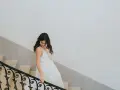 Une mariée descend un escalier, sa robe blanche fluide. Un moment clé pour comment choisir sa robe de mariée.