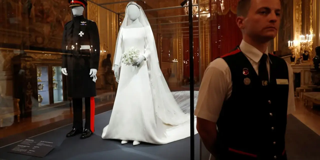 La robe mariée Meghan Markle, d'une élégance intemporelle, est exposée aux côtés de l'uniforme du Prince Harry.