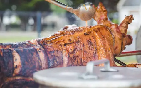 Un cochon à la broche doré et juteux, arrosé d'une sauce savoureuse. Un accompagnement parfait pour une fête mémorable.