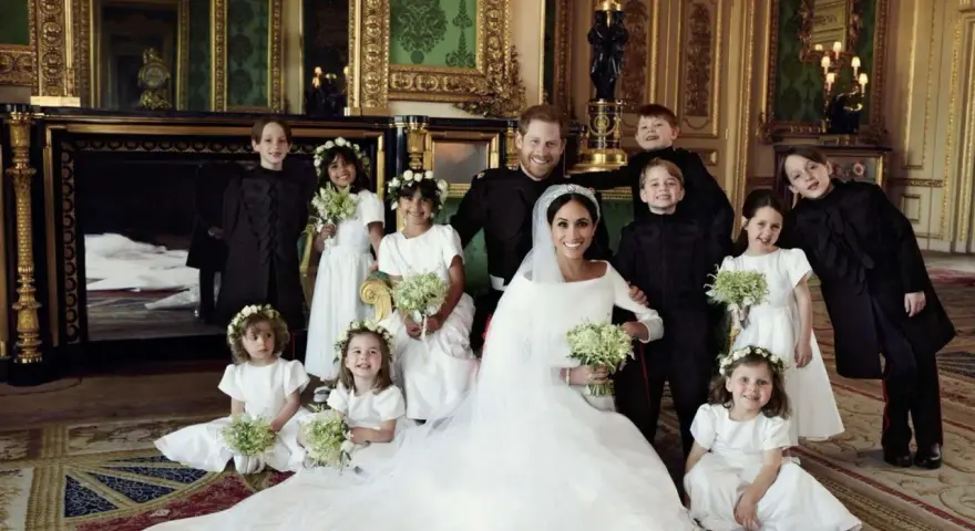 Mariage Harry et Meghan : le couple royal pose avec les enfants d'honneur dans un salon luxueux.